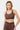 Brassière de sport Judoka Léopard portée de face, motif léopard brun, bande élastique marron à logo cœur