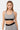 Brassière de sport Judoka Zèbre portée de face, motif zèbre, bande noire à logo cœur brodé sous la poitrine