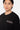 T-shirt Juicy Noir porté par un mannequin homme, gros plan de face, logo Eleven blanc et rose sur la poitrine