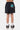 Short Jarine Noir Délavé porté de dos, numéro 22 turquoise French Riviera Elevenparis sur la poche, baskets noires