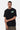T-shirt June Noir Délavé porté de face par un mannequin homme, petit cœur planète vert fluo sur la poitrine