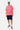 T-shirt June Rose porté en pied par un mannequin homme avec short cargo bleu marine, casquette et baskets roses et vertes