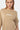 T-shirt Juno Beige porté par une mannequin femme, gros plan de face sur le logo Eleven blanc, manches larges