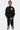 Jogging Joyau Noir porté en pied par un enfant avec sweat noir assorti, cœur vert sur la cuisse, baskets noires et blanches