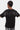 T-shirt Juveli Noir porté de dos par un enfant, lettrage gothique Eleven en strass argentés sur les épaules