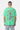 T-shirt Jwin Vert porté de dos par un mannequin homme, In the end l'amour win en lettres colorées, jean clair