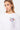 T-shirt Jwin Blanc porté par une mannequin femme, gros plan de face sur la petite inscription L'amour win multicolore