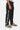 Jogging Fiston Noir porté par un enfant, vue de profil avec inscription ELVNPRS en lettres blanches sur la jambe