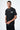 T-shirt Lys Noir delavé porté par un mannequin homme avec chaîne argentée, vue de trois quarts face