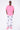 T-shirt Lys Rose délavé porté par un mannequin homme avec pantalon blanc à motifs gris et baskets roses, vue de face en pied