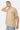 T-shirt Lys Beige porté par un mannequin homme, bras relevé derrière la tête, jean clair et bracelet