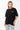 T-shirt Lys Noir Strass oversize porté par une mannequin femme avec jean clair, vue de face et inscription en strass