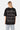 T-shirt Lys Noir Strass porté par une mannequin femme, vue de dos avec inscription Another Fucking Bonjour Madame en strass