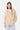 Sweat à capuche zippé Moon Beige porté par une femme de face, cordons tressés et surpiqûres colorées sur la poche