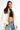 Sweat à capuche zippé Moon Écru porté par une mannequin femme avec top noir à coeur et jean, cordons tressés colorés
