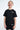 T-shirt Naava Noir porté par un garçon qui rit, de face, inscription ElevenParis sur la poitrine