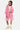Short Ninon Rose porté par une femme avec sweat zippé rose assorti et t-shirt blanc, de face en pied, baskets crème