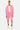Short Ninon Rose porté par un homme avec sweat zippé rose assorti et débardeur blanc, de face en pied