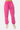 Jogging Paradis Rose délavé porté par une mannequin femme, vue de face, logo ELEVEN PARIS sur la cuisse, baskets roses