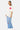 T-shirt Parma Écru ample porté par une mannequin femme de trois quarts, coeur fuchsia sur la poitrine, pantalon rayé bleu