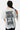 T-shirt Parma Gris délavé vu de dos sur une mannequin femme, grande inscription noire More amour por favor