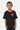 T-shirt Patras Noir porté par un garçon, plan buste de face, coeur rouge souriant imprimé sur la poitrine
