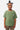 T-shirt Perle Kaki porté par une fille souriante, vue de face, trois coeurs imprimés sur la poitrine, pantalon camouflage