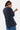 T-shirt Pharell Noir Délavé porté par une mannequin femme de dos et de profil, dos uni, jean bleu