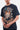 T-shirt Pharell Noir Délavé porté par un mannequin homme, zoom sur le crâne en flammes et le lettrage Paname Crève Coeur