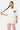 T-shirt Pinerolo Écru porté par une mannequin femme en pantalon rose, vue de face, coeur souriant en mosaïque violet et rose