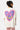T-shirt Pinerolo Écru porté par une mannequin femme de dos, grand coeur souriant en mosaïque violet, rose et jaune