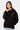 Sweat à capuche Poncho Noir oversize porté par une mannequin femme, vue de face, fleurs de lys motif léopard brodées