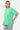 T-shirt Portofino Vert porté par un mannequin femme, de trois quarts, trois cœurs empilés sur la poitrine, jean clair