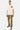 T-shirt Power Écru porté en pied par un mannequin homme, poche écusson terracotta, pantalon cargo camouflage