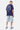 T-shirt Punky Bleu Marine porté par un mannequin homme, de dos, smiley en lettrage gothique, short en jean clair et baskets