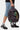 Sac à dos Jalley Bandana Noir imprimé bandana paisley, inscription Elevenparis, tenu à la main avec short en jean