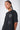T-shirt Saule Noir Délavé porté par un mannequin femme, de trois quarts, trois cœurs blancs et gris aux yeux en croix