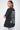 T-shirt Saule Noir Délavé porté par un mannequin femme, de dos et de profil, bras croisés, lettrage Love Amor, jogging gris