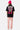Pantalon cargo Suede Rose porté vu de dos, t-shirt noir SUPPORT OUR LOCAL LOVER DEALER et bonnet fuchsia