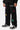 Jogging Tahar Noir porté de face par un enfant, inscription Elevenparis blanche et étoiles colorées sur la jambe