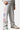 Jogging Tess Gris Chiné porté, de trois quarts, cordon de serrage, cœurs smiley colorés sur la jambe, baskets à lacets verts