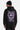 Sweat à capuche Tevy Noir porté par un homme, de dos, graffiti violet cœur et inscriptions Vandals Gone Over Peace