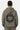 Sweat à capuche Theodora Kaki porté par une femme, de dos, fleur noire à cœur smiley et inscription City of ELVN