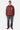 Pull polo Thomas Rouge en maille rayée porté par un homme en pied, avec jean gris à fleurs de lys et baskets bordeaux
