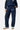 Pantalon de survêtement Tunis Bleu Marine porté de face par une mannequin femme, bandes noires, inscription Eleven brodée