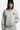 Sweat à capuche zippé Tyson Gris Chiné porté de face par une mannequin femme avec un bonnet noir, main dans la poche