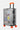 Valise Fugers Argent S de trois quarts, coque gris argenté, patchs colorés, poignée latérale, cadenas, roulettes orange