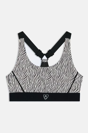 Brassière de sport Judoka Zèbre à plat de face, imprimé zèbre, bretelles noires croisées et coeur sur la bande