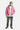 Blouson Eschott Rose porté en pied par un mannequin homme avec jean gris à croix brodées et baskets noires