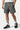 Maillot de bain short Jamaique Kaki à motif gris en plan rapproché, cordon blanc et petit cœur doré sur la cuisse
